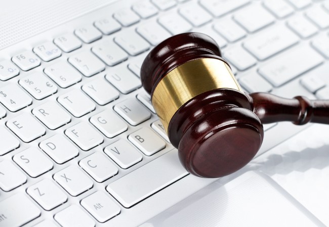 Close up of wooden gavel at the computer keyboard